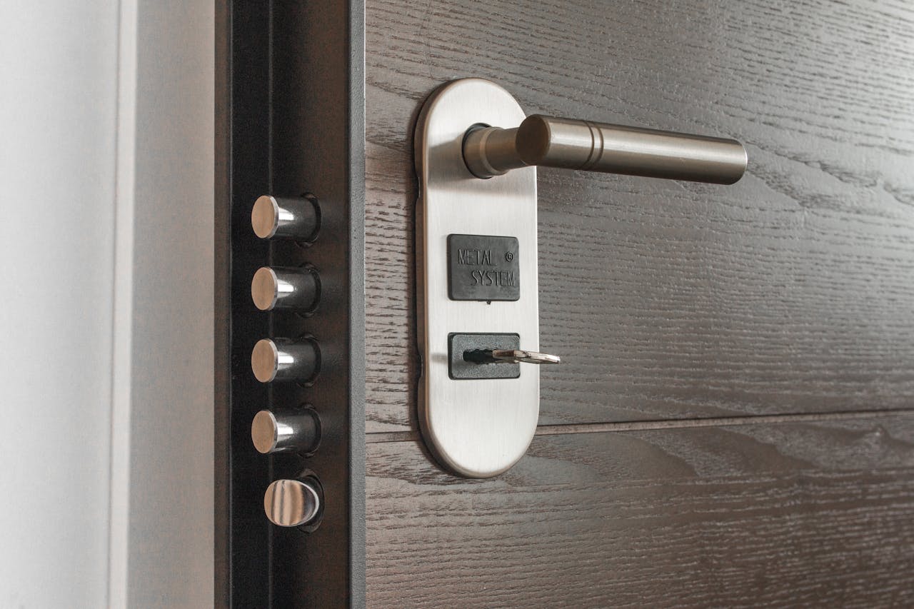 why-choose-us Metal door handle and lock system with key inserted, showcasing security features.